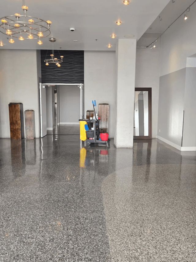 Day porter with janitorial cart maintaining a polished commercial lobby in Las Vegas